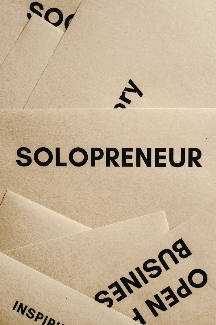 Minimalist solopreneur business cards laid out conceptually in a creative stack.